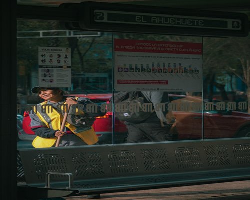 person checking phone inside a busy Metrobús in Mexico City
