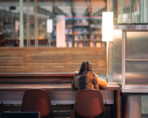 person reading a physical book in a comfortable room lit by warm evening lamps in Mexico